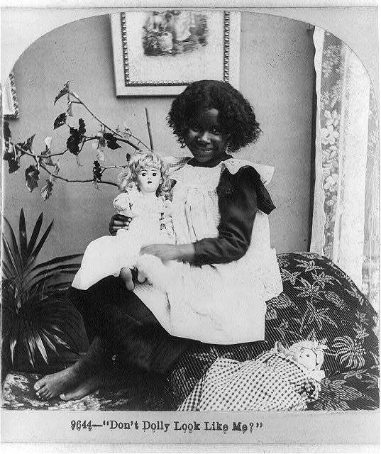 Photo:Negro child with white doll