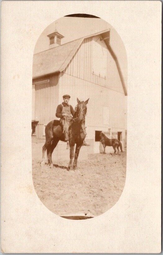c1910s Real Photo RPPC Postcard Young Man in Denim Overalls on Horse / Barn View