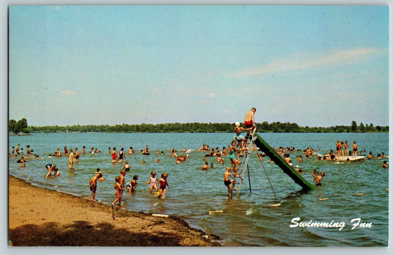 SCENE OF FAMILIES SWIMMING IN A LAKE SWIM SLIDE VTG POSTCARD