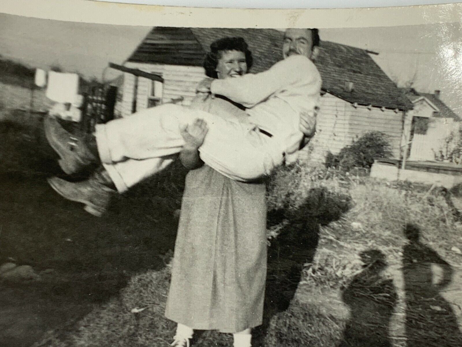 AgF) Found Photo Photograph Woman Picking Up Man Carrying Shadow People Odd