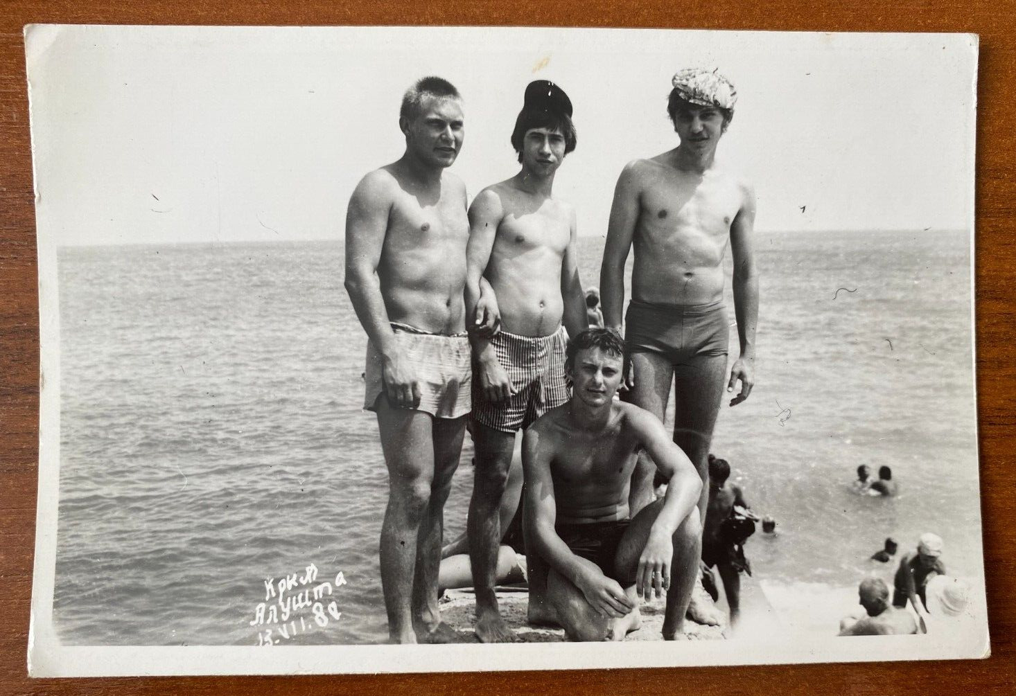 Affectionate gentle men on the beach, guys in swim trunks, naked torso, gay int