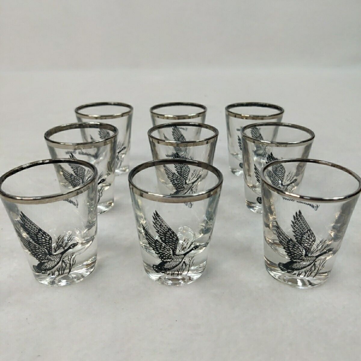 Set of 9 Vintage bird shot glasses Canada Goose EXCELLENT Silver Rim