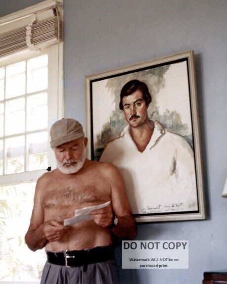 ERNEST HEMINGWAY IN FRONT OF PORTRAIT OF HIMSELF CIRCA 1953  8X10 PHOTO (AA-277)