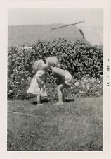 1950s vintage PHOTO ADORABLE 1957 baby toddler KISSING in yard VERY CUTE vintage picture