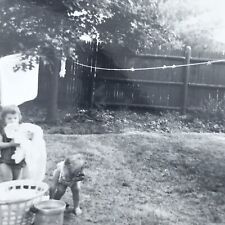 Vintage 1965 Black and White Photo Children Taking Laundry Off Line Backyard picture