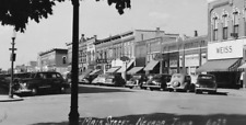 RPPC c1951 Main Street Neveda Iowa Old Cars Cafe Stores Lamps Vintage Postcard picture