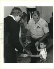 1995 Press Photo Patrick Taylor helps Richard Pennington present Medal to Father picture