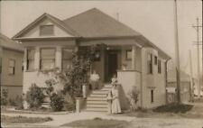 1909 RPPC Newcastle,WY Family on Steps of House Weston County Wyoming Postcard picture