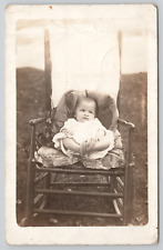 RPPC Baby Sitting In Rocking Chair Playing With Feet c1910  Real Photo Postcard picture