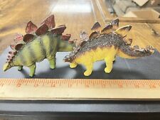 Carnegie Collection Stegosaurus dinosaur pair--original and revised paint picture