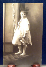 Antique 1904-1918 RPPC Pretty Girl holding Antique Doll, Bow in Hair picture