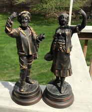 PAIR OF VINTAGE SPELTER STATUES, WOMAN WITH FISH, MAN WEARING TAM picture