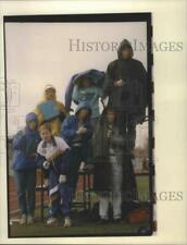1993 Press Photo Timers peer through bad weather at North Central track event picture