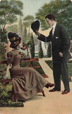 Postcard Antique C1910 Man Tipping to a Lovely Lady Sitting on a Bench picture