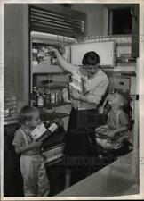 Press Photo Mrs. Howard Garland Stores Frozen Food with her Sons - cvb64339 picture