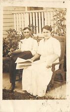 Real Photo Postcard~Carrie & Charlie Reading Newspapers by Roses~Porch~1912 RPPC picture