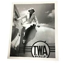 Photo TWA Press 8x10 B&W Flight attendant sitting on luggage cart at plane picture