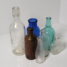 Vintage Mix of 7 Old Cork Top Bottles In A Variety Of Sizes And Colors Display picture