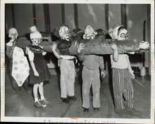 1957 Press Photo Children dressed as clowns carrying a paper log, Ohio picture
