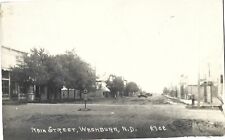 Washburn ND -- Main Street, store fronts, Model T's; nice 1928 RPPC picture