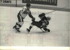 1994 Press Photo Badger defenseman Mark Strobel routs a Minnesota hockey player picture
