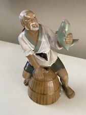Vintage Mud Man Pottery Figurine 7” Tall With Fish picture