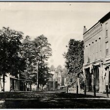c1910s Mystery Downtown View RPPC Main St Stores Dirt Road Real Photo PCard A96 picture