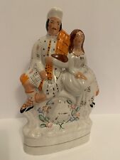 *Reproduction* Staffordshire figurine of man & woman sitting on a clock picture