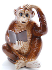 Monkey holding book hand on head ceramic figurine 7.25