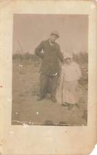 RPPC Man and Woman Outside Postcard picture