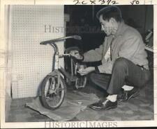 1961 Press Photo Cuban refugee Jose Llera paints an old bike in New Orleans. picture