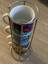 ROMERO BRITTO SET OF 4 ASSORTED CERAMIC COFFEE MUGS NEVER USED WITH HOLDER picture