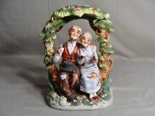Loving Elderly Couple Sitting On A Bench Under An Arbor Figurine picture