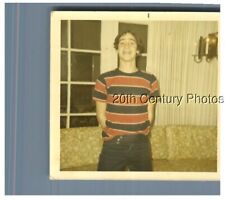 FOUND COLOR PHOTO R_2211 MAN SMILING BY COUCH,HANDS BEHIND BACK picture