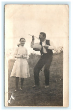 1907-1914 Comical Man Eating out of Pot and Young Girl RPPC Outdoor Postcard picture