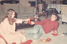 Vintage 1960s Photo Handsome Young Man Girl Opening Christmas Stocking picture