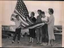 1954 Press Photo Ladies & students lower and fold flag at Boysville, Texas picture
