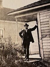 1920s RPPC: MAN HOLDING UP A LEANING HOUSE antique real photo postcard AMERICANA picture