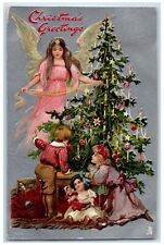Christmas Greetings Angel And Children Decorate Christmas Tree Tuck's Postcard picture