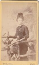 VICT. CDV PHOTO. LADY AT WOODEN FENCE/HAT/FLOWER BASKET/PAINTED BACK.TODD,OTLEY picture