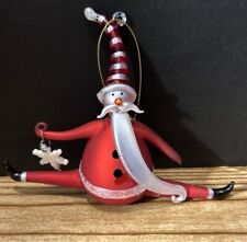 whimsical santa ornament holding snowflake and doing splits picture