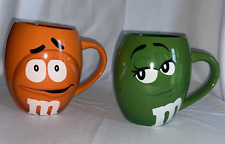 Lof 2 M&M's World Green Orange Oversized Mugs I'm Irresistable I Melt For No One picture