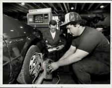 1989 Press Photo Christopher Engelhard aligns tires at Pathfinder H.S., MA picture