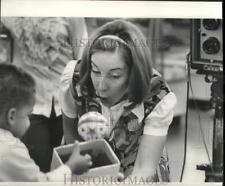 1970 Press Photo Photographer Pam Krescheck tries extra hard to bring a smile picture