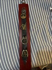 4 Vintage Brass Horse Medallions mounted to strap and wood panel picture
