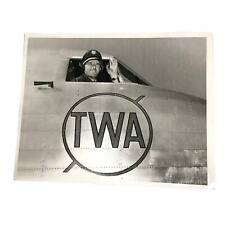 Photo TWA Press 8x10 B&W Pilot waving from cockpit of plane over TWA logo picture