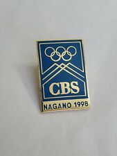 CBS Nagano 1998 Winter Olympic Games Souvenir Pin Light Blue And Gold Colored picture