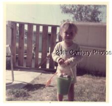 FOUND COLOR PHOTO F_9994 CHILD IN YARD HOLDING BUCKET picture