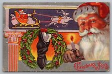 Christmas Joys Santa Claus Candle Stocking Holly Wreath Sleigh Postcard picture