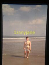 3Y17 VINTAGE Photo 35mm Slide WOMAN WALKING ON BEACH IN WHITE HOLDING SHOES  picture